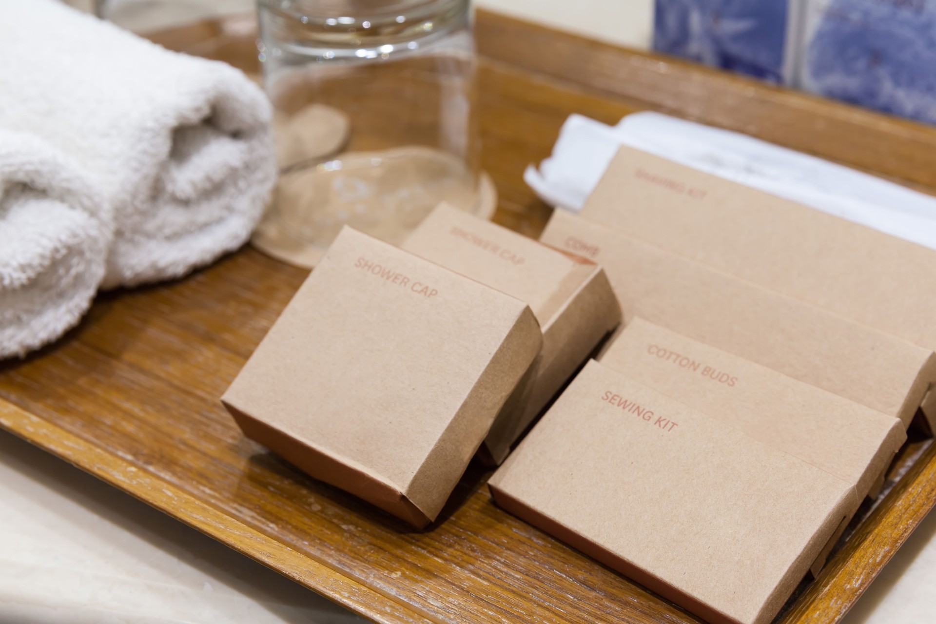 Closeup amenity kit in the brown boxes on the wooden tray